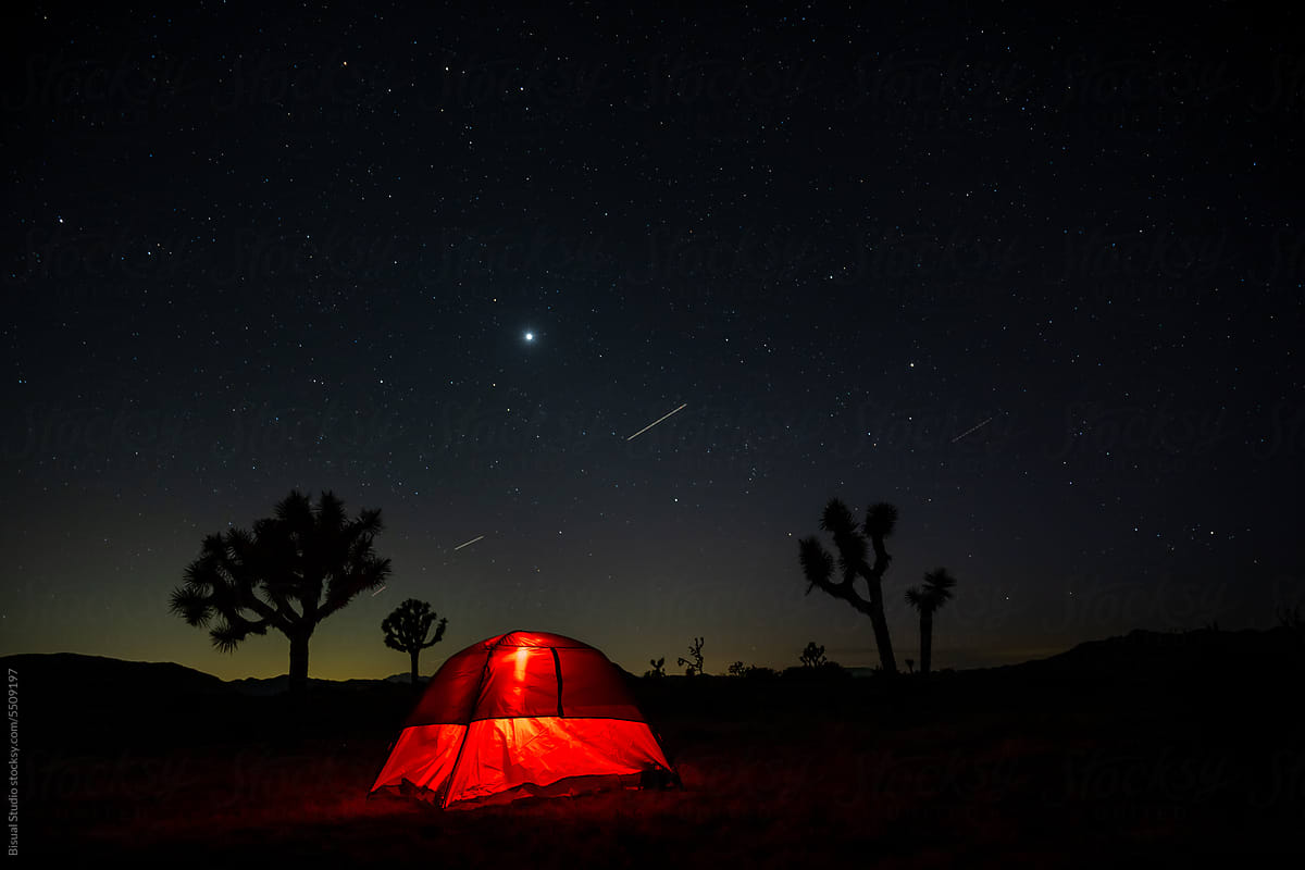 Red mountain tent lit up in Joshua Tree