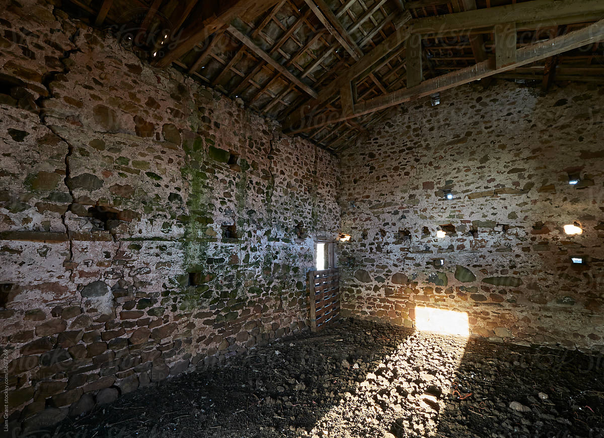 Morning light on the interior of an old stone barn. Cumbria, UK.