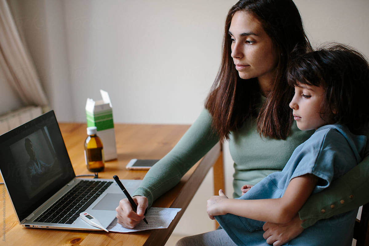 Young mother and daughter doing an online consultation with a doctor
