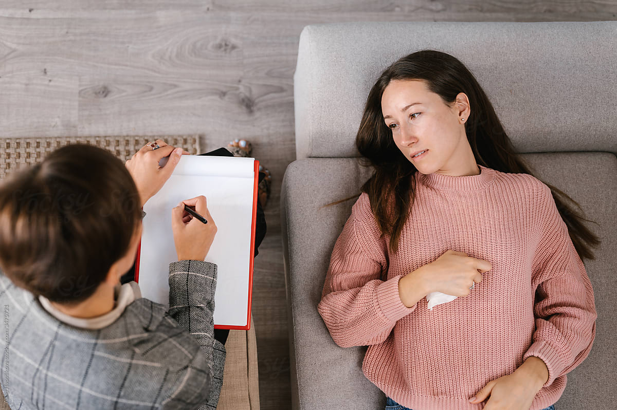 Psychologist helping woman during psychotherapy session