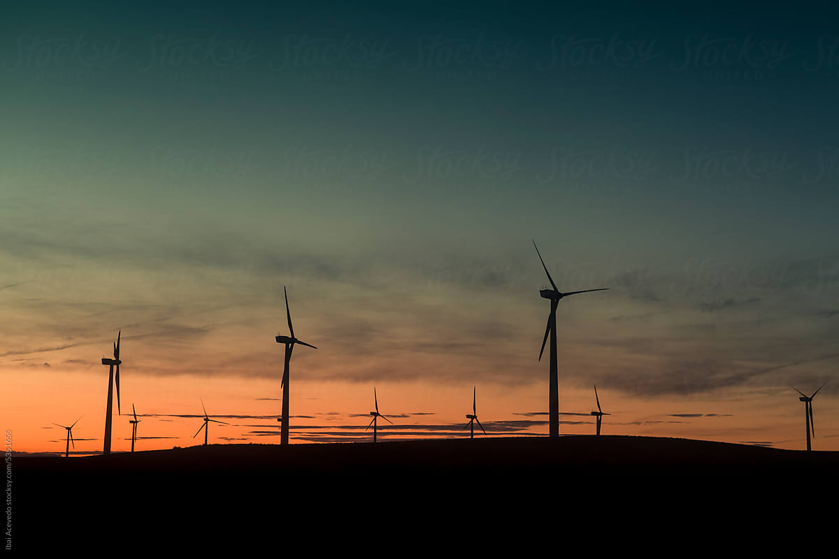 Renewable energy with wind turbines at sunset