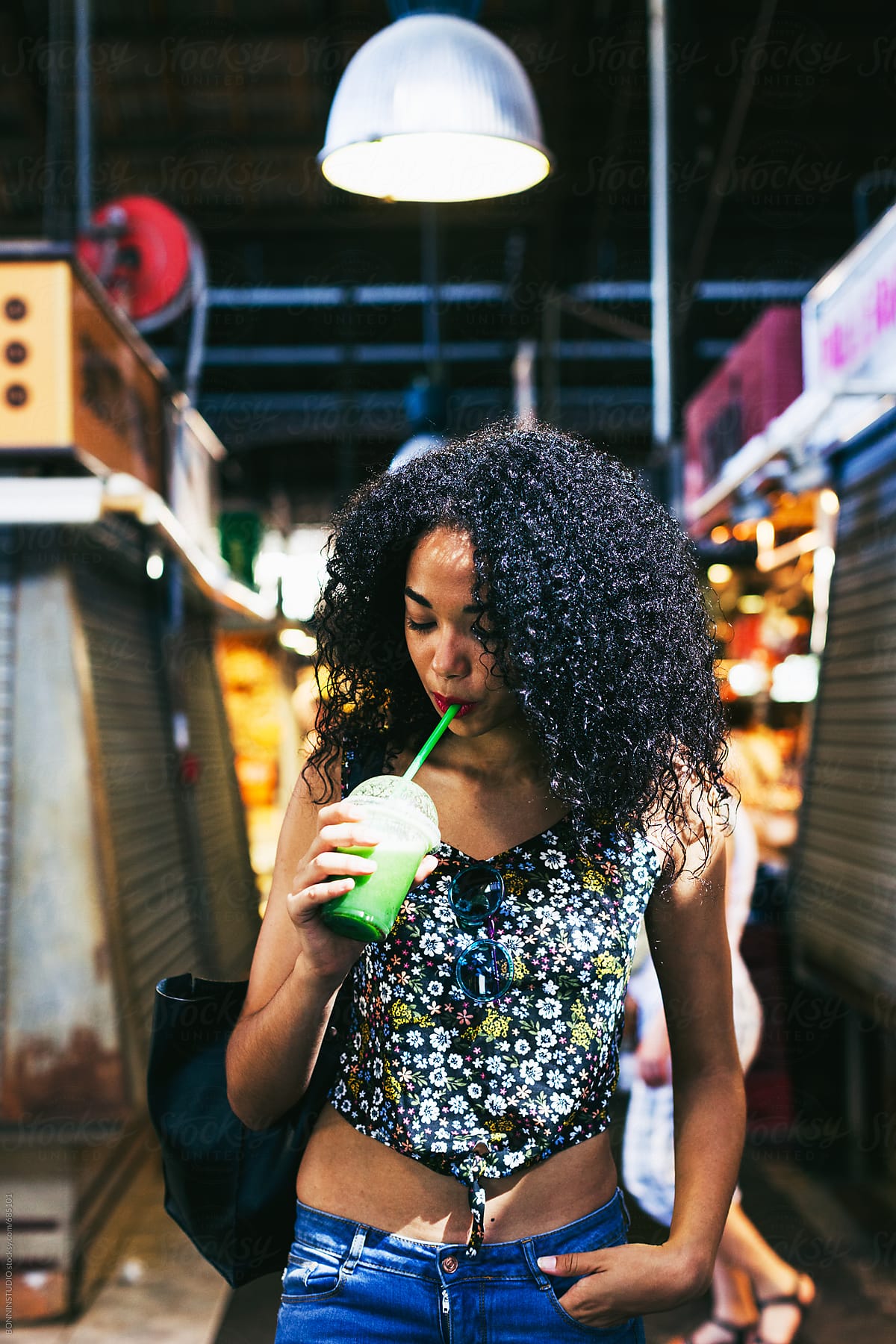 Young Latin Woman Drinking A Smoothie Standing On A Marketplace By 8859