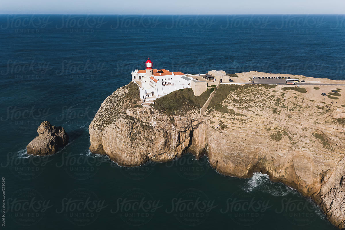 Aerial view of a lighthouse at the edge of the cliff