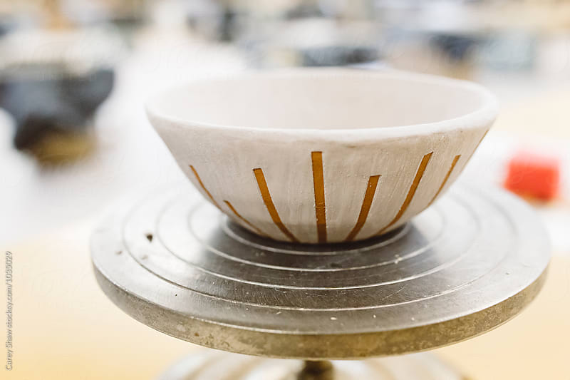Clay bowl with glaze design on wheel
