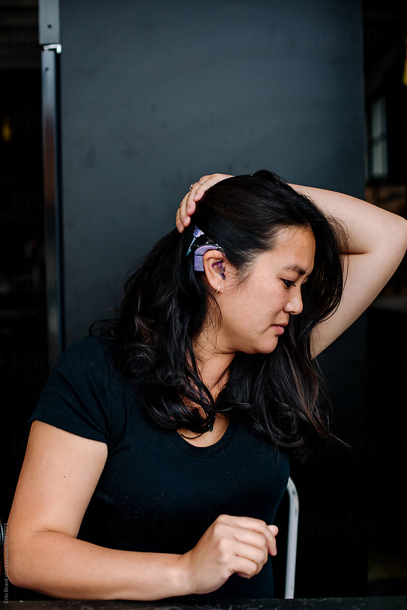 Profile of Asian woman with cochlear implant