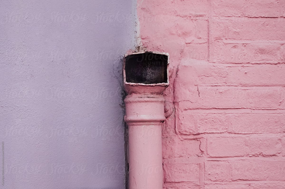 Pastel Purple and Pink Wall With a Pink Pipe on it