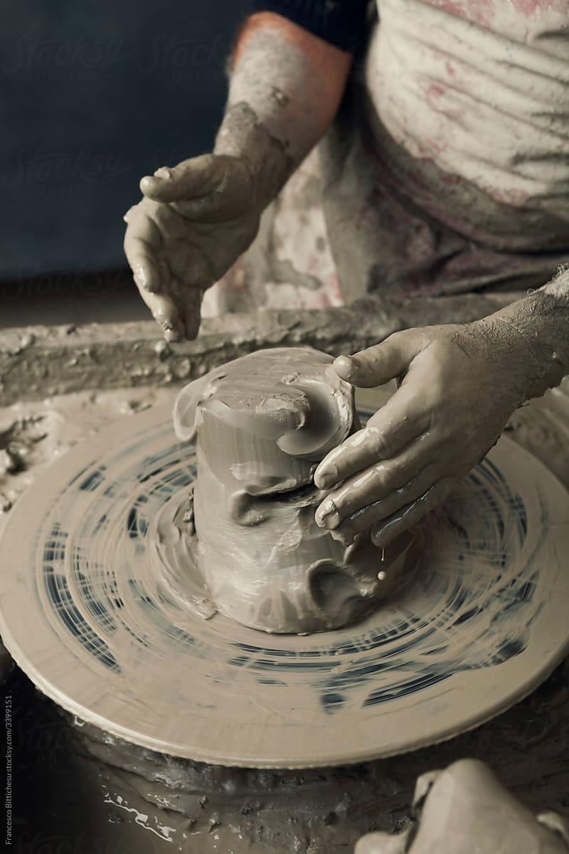 Ceramist, man\'s hands working on clay