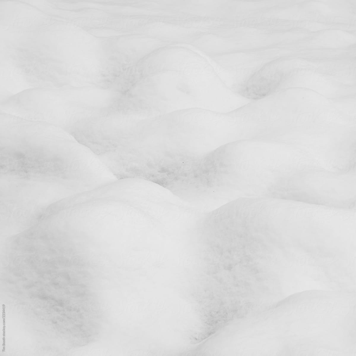 Drifts of snow over a lumpy landscape
