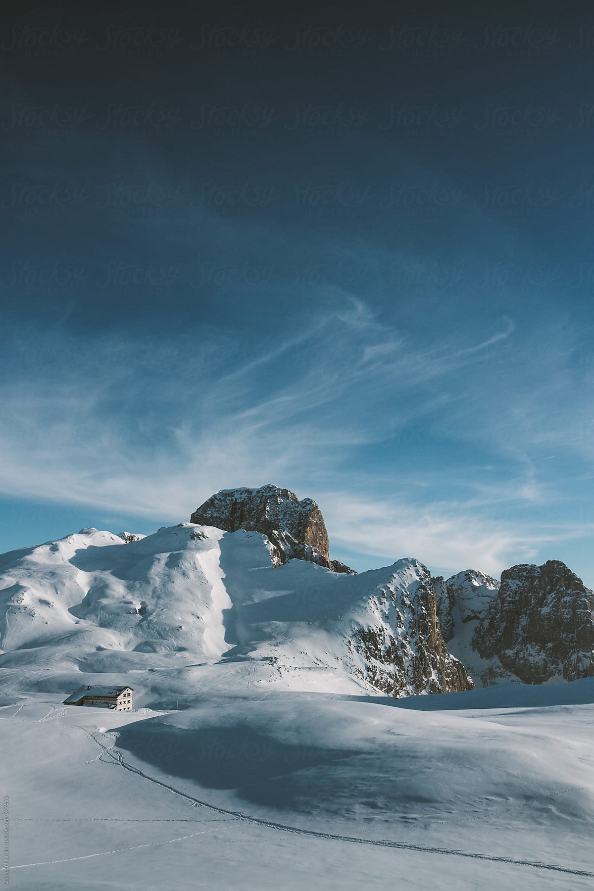 mountain shelter in snowcovered alpine winter landscape in the italian alps