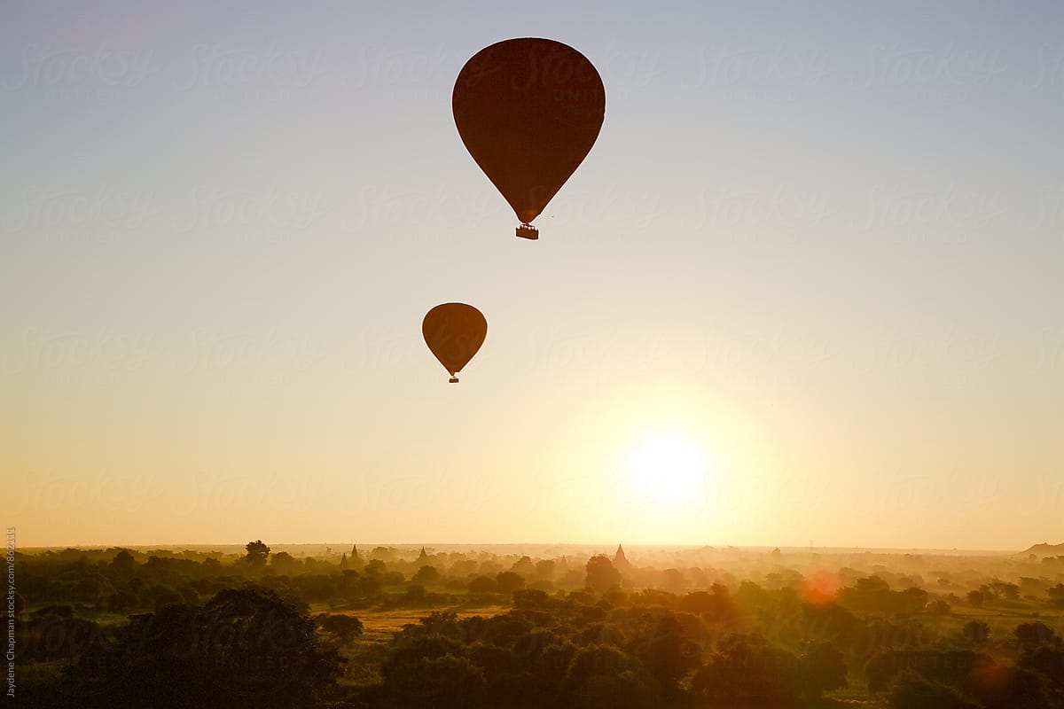 Magical balloons over Bagan with silhouettes of strangers