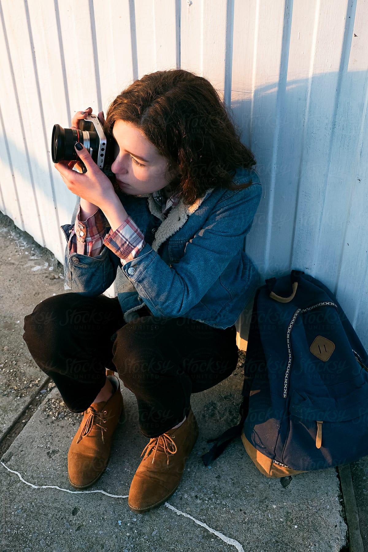 Young brunette taking shot using film camera