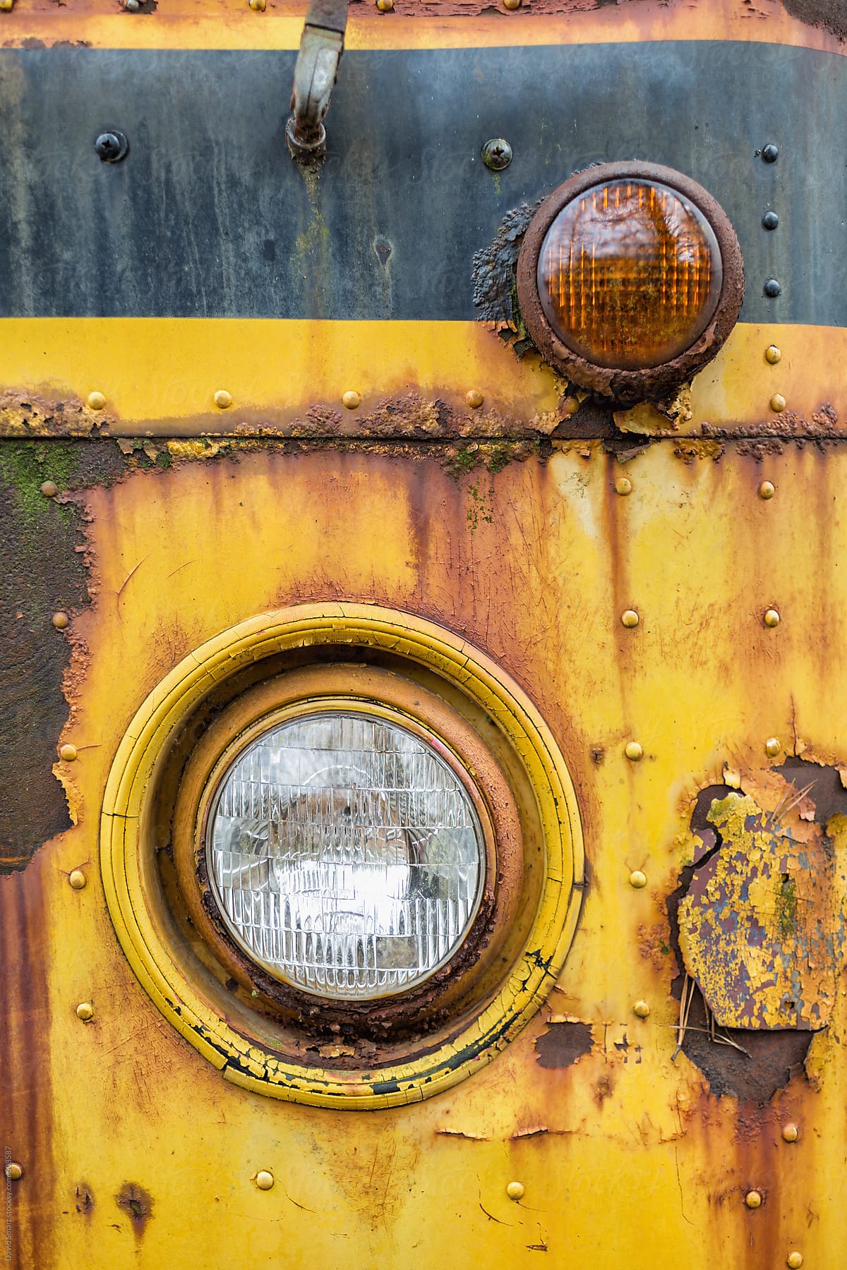 Headlight on an abandoned and decaying school bus