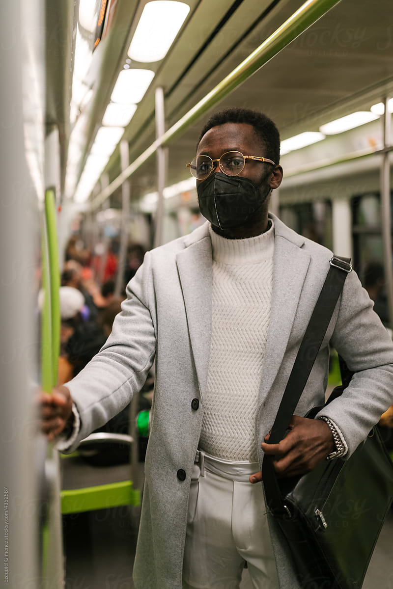 Black man in mask in underground wagon