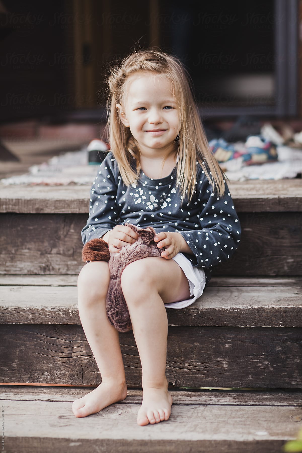 Cheeky Girl Sitting On The Porch By Stocksy Contributor Irina