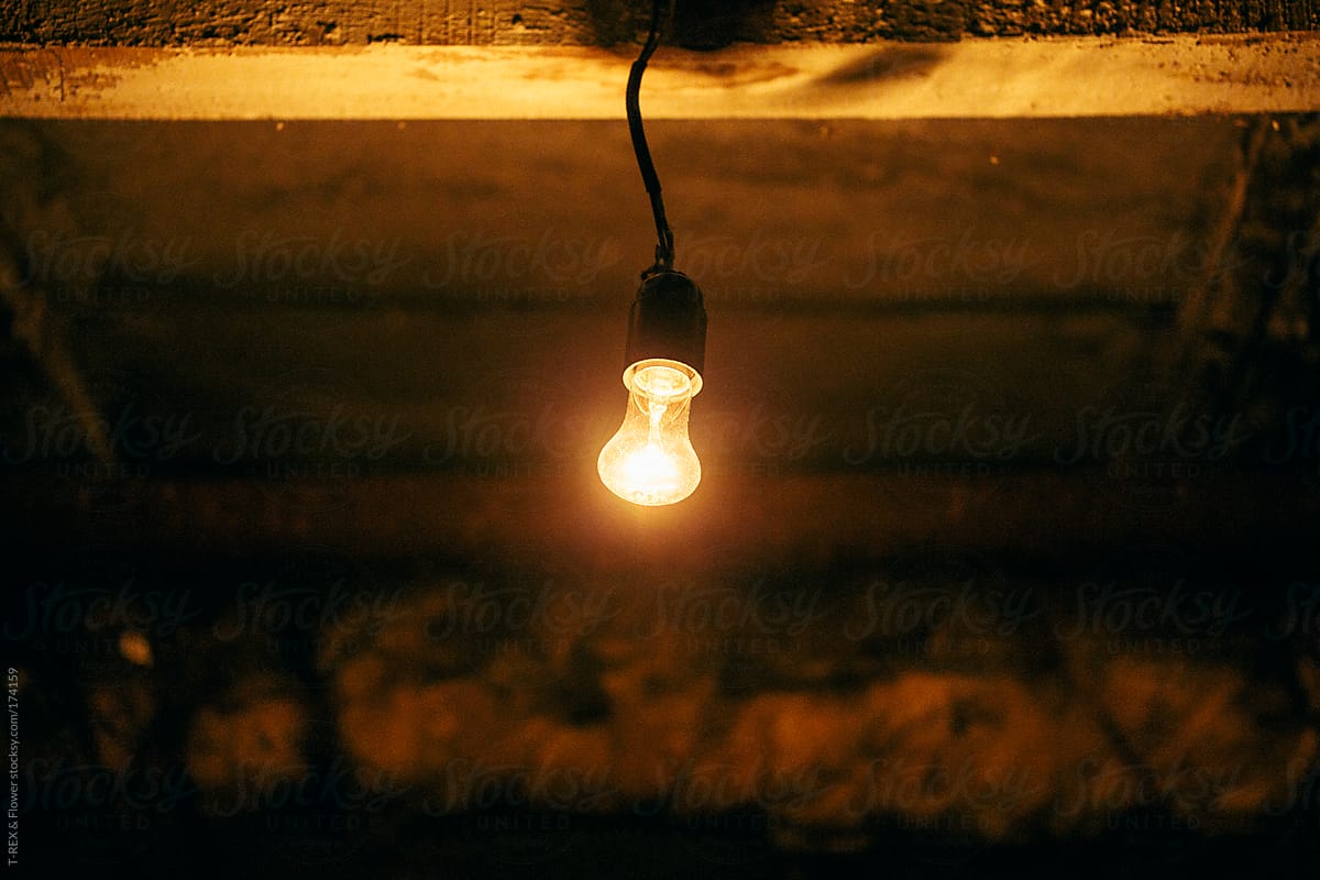 Dim Light Bulb" by Stocksy Contributor "Danil Nevsky" - Stocksy