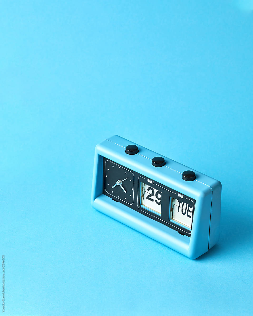A blue retro style flip clock with date and time