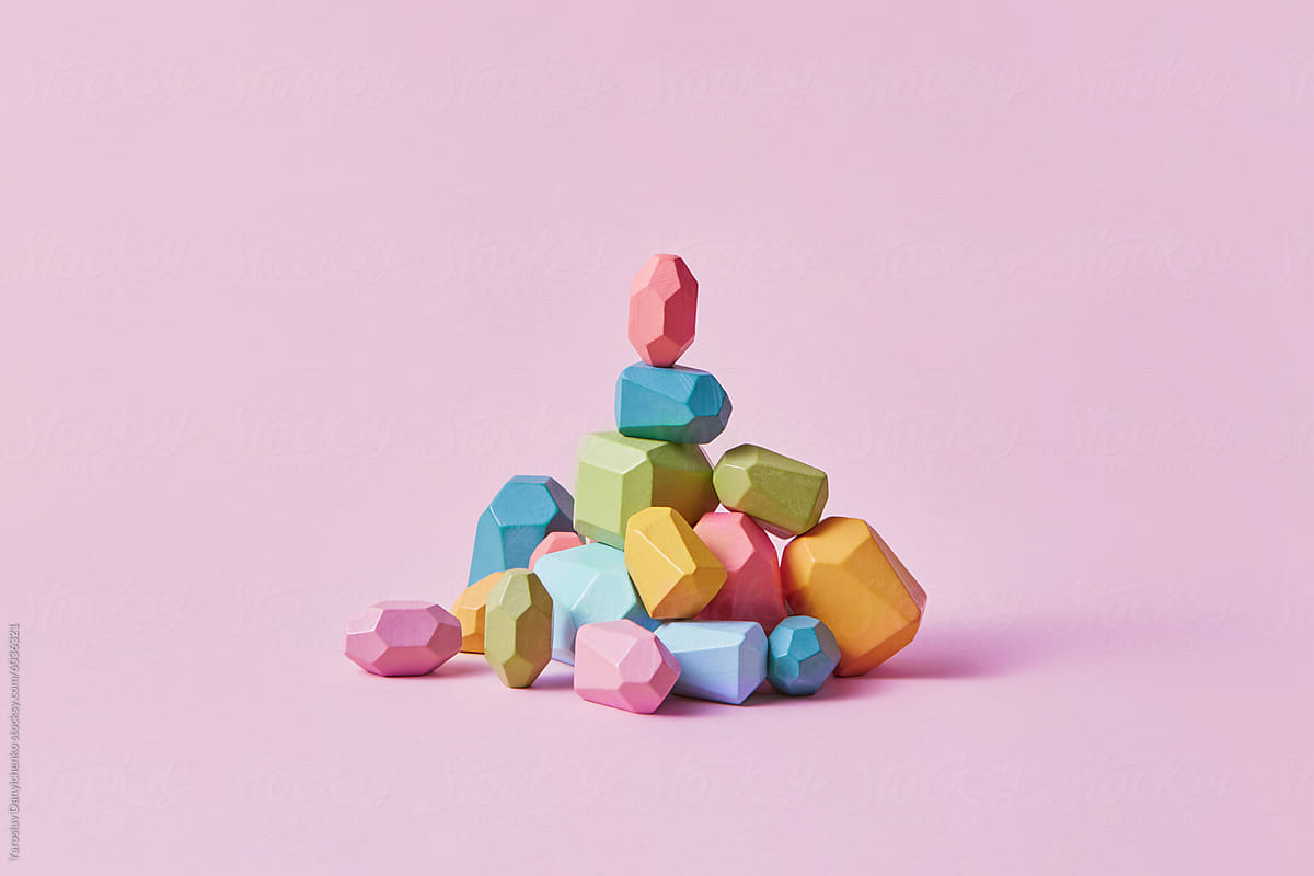 Colorful wooden balancing stones in polygonal shape lying in heap