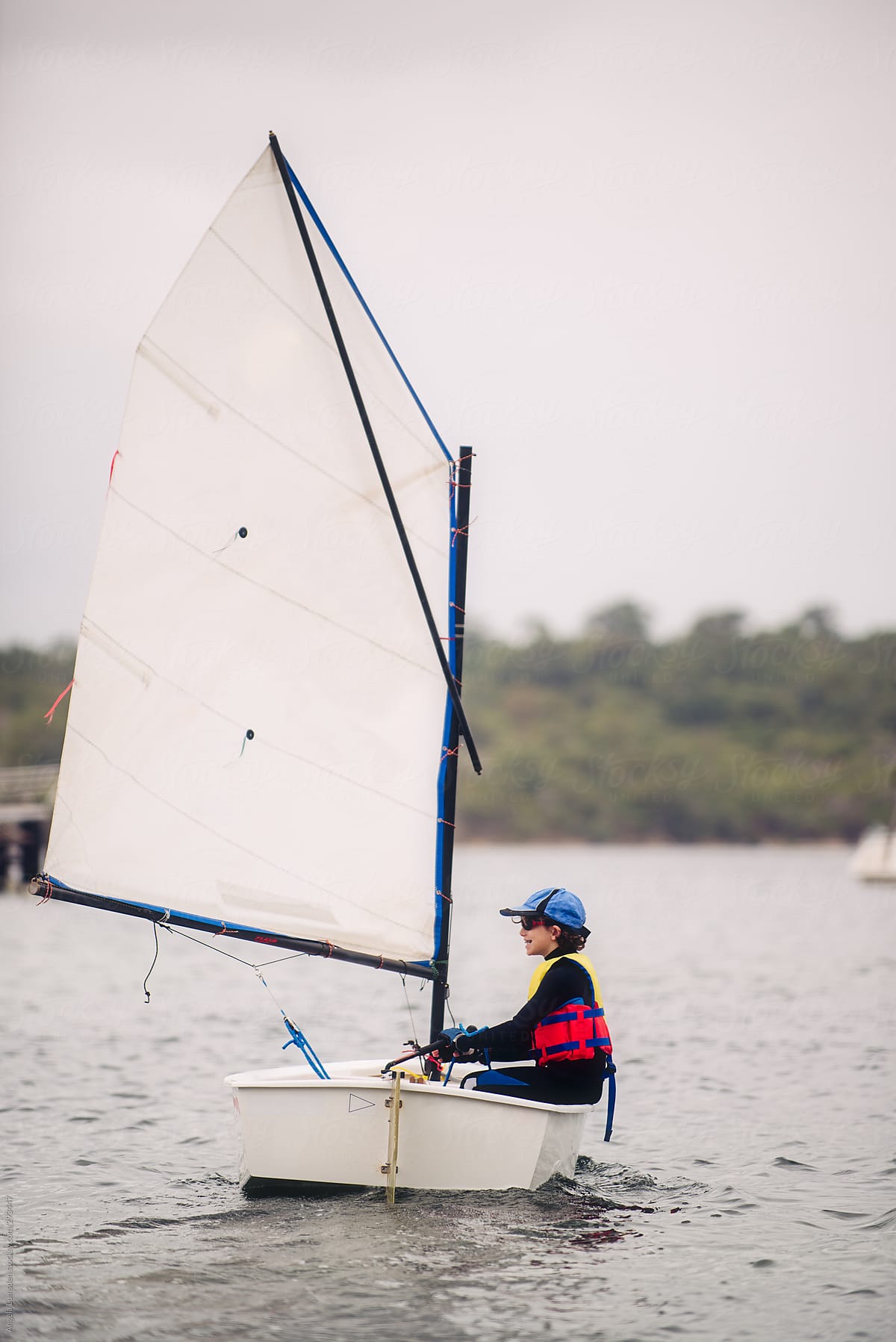 Young boy happy to be sailing a dinghy
