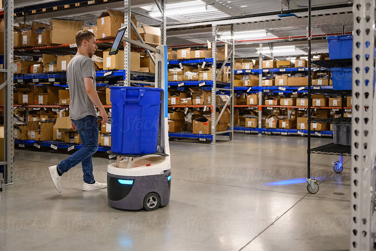 Manager with digital Robot on floor at Warehouse