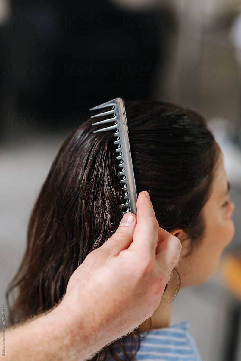 Hairdresser Combing Hair