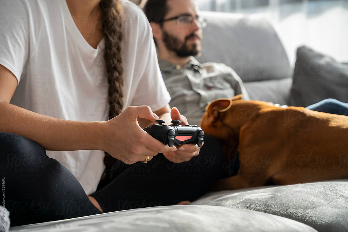detail of couple playing videogames in living room