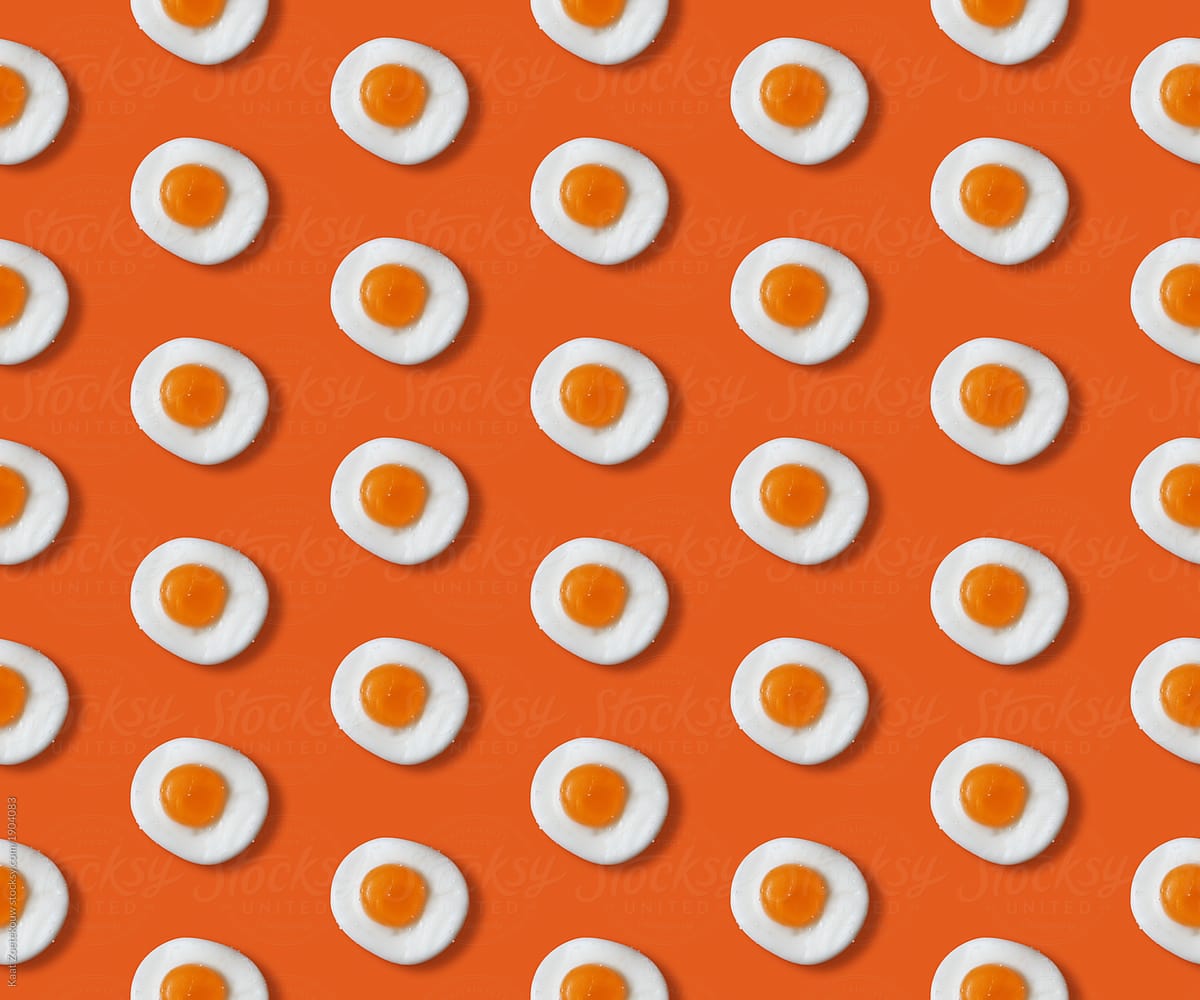 Sunny side up candy with sugar sprinkled on it (salt) in a pattern on an orange background