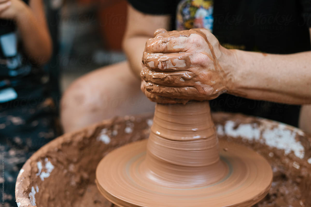 Anonymous potter shaping clay vessel