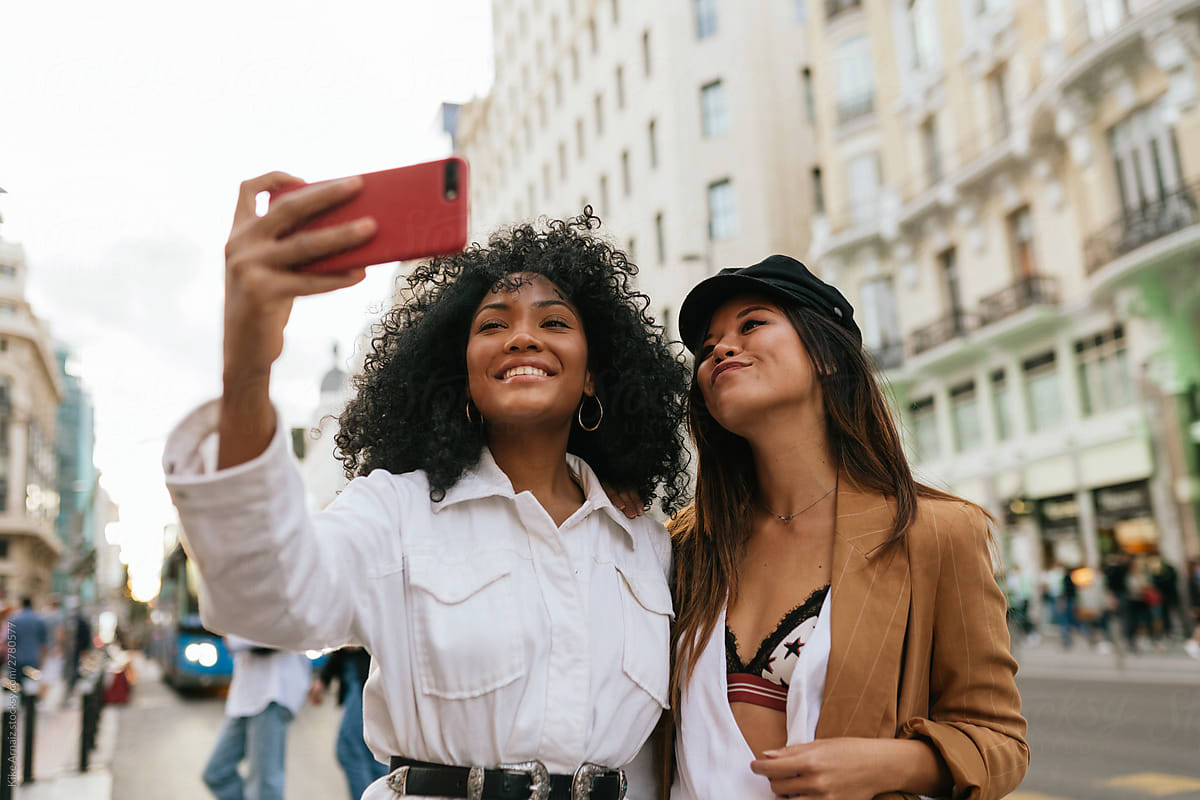 African american and asian women taking a selfie