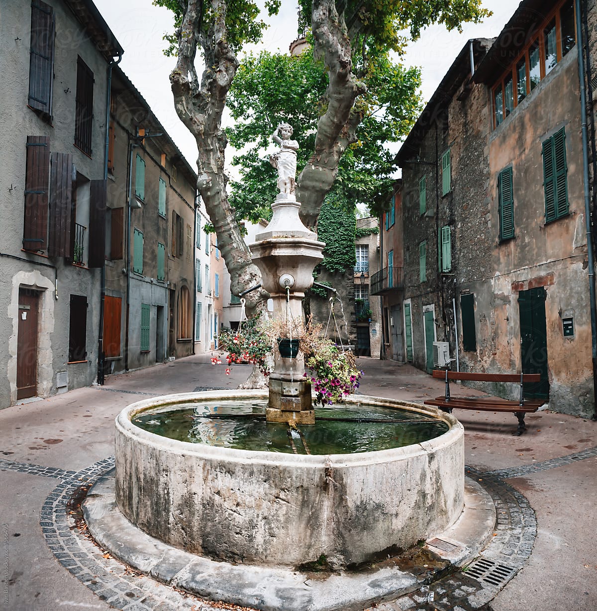 Fountain on a public square in an old village in the south of France (Provence)