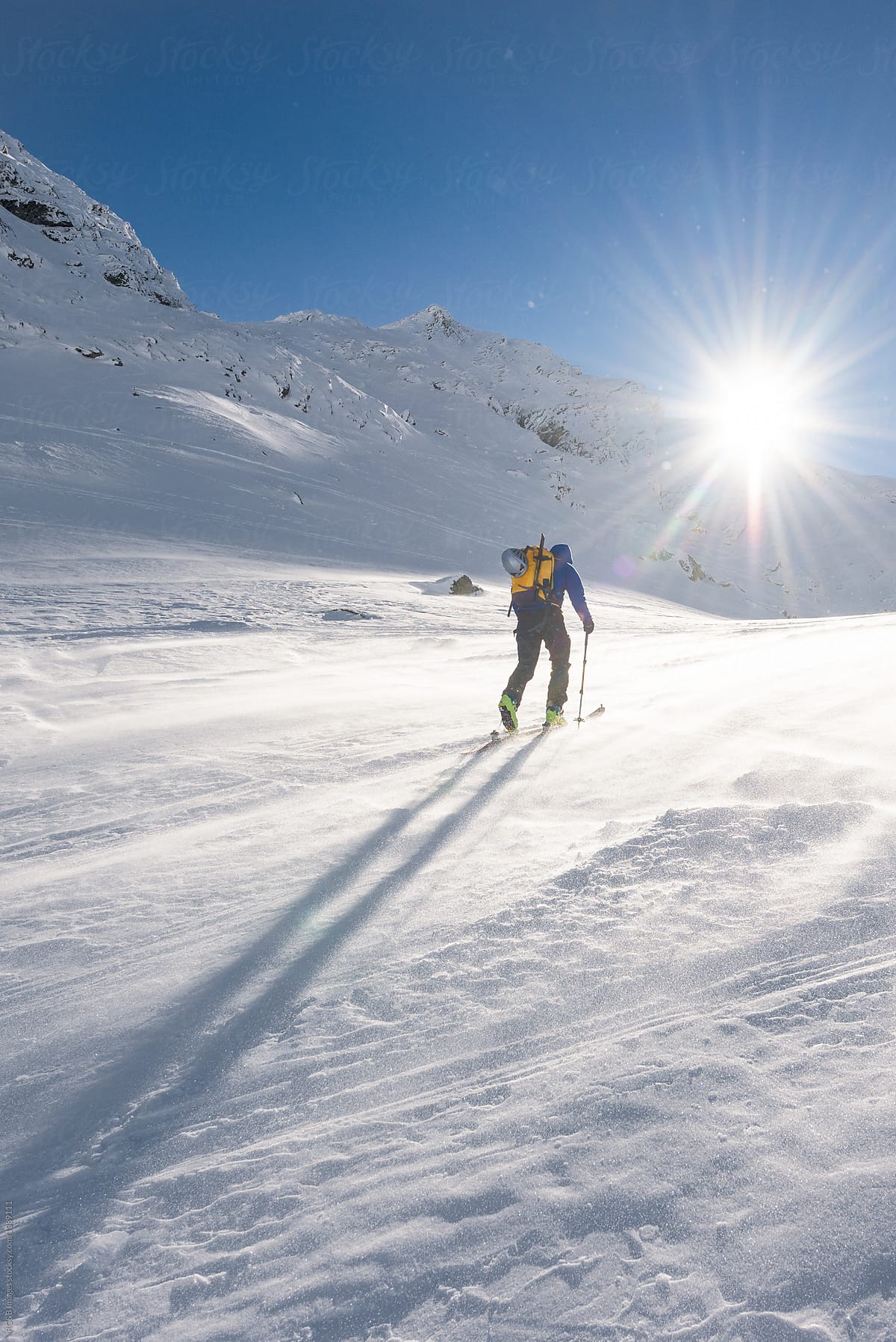 Man ski touring on a sunny winter day