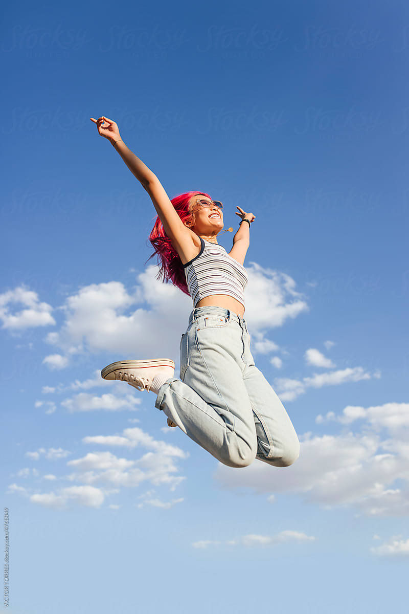 Carefree chinese woman jumping and enjoying freedom