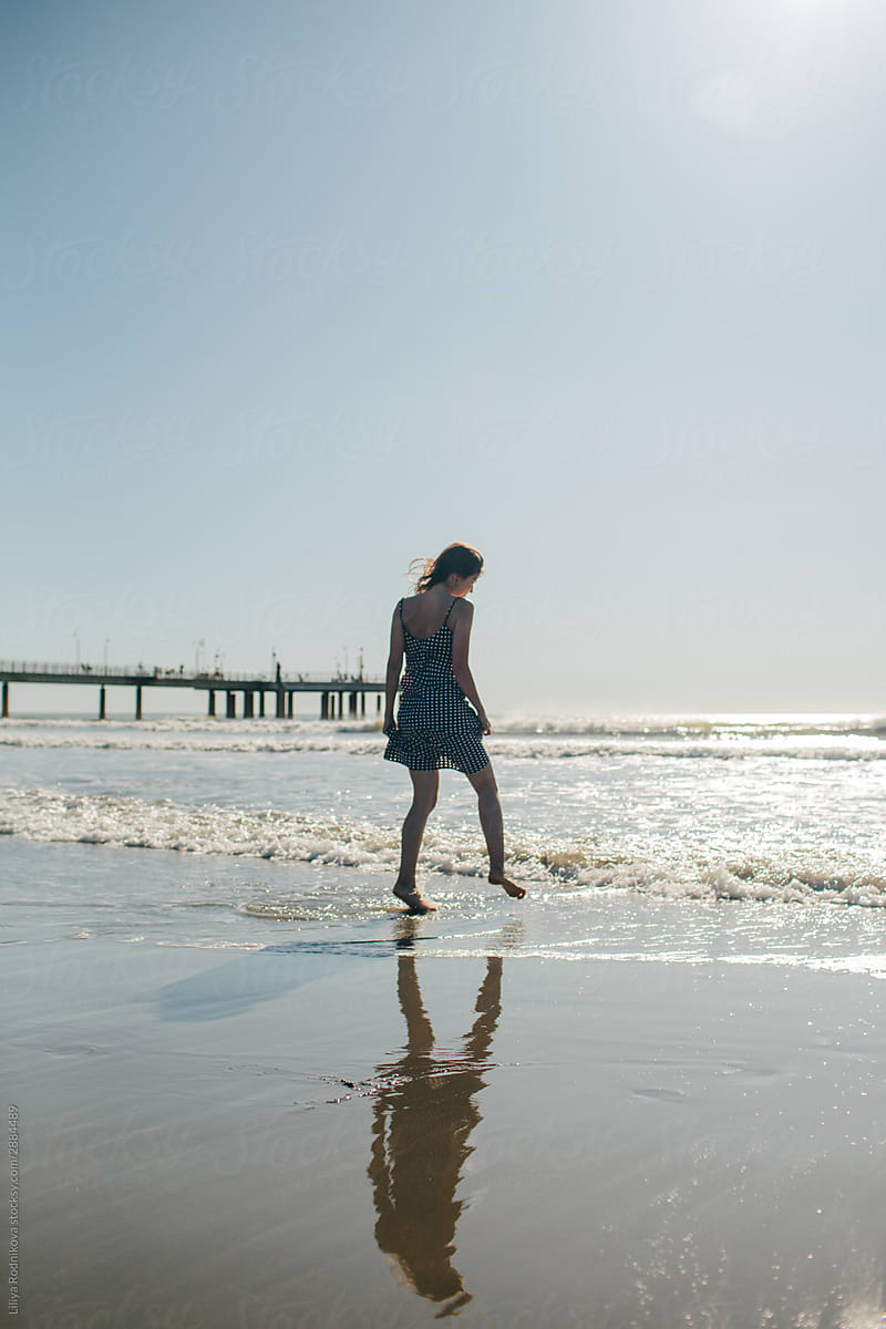 Woman walking by the shoreline
