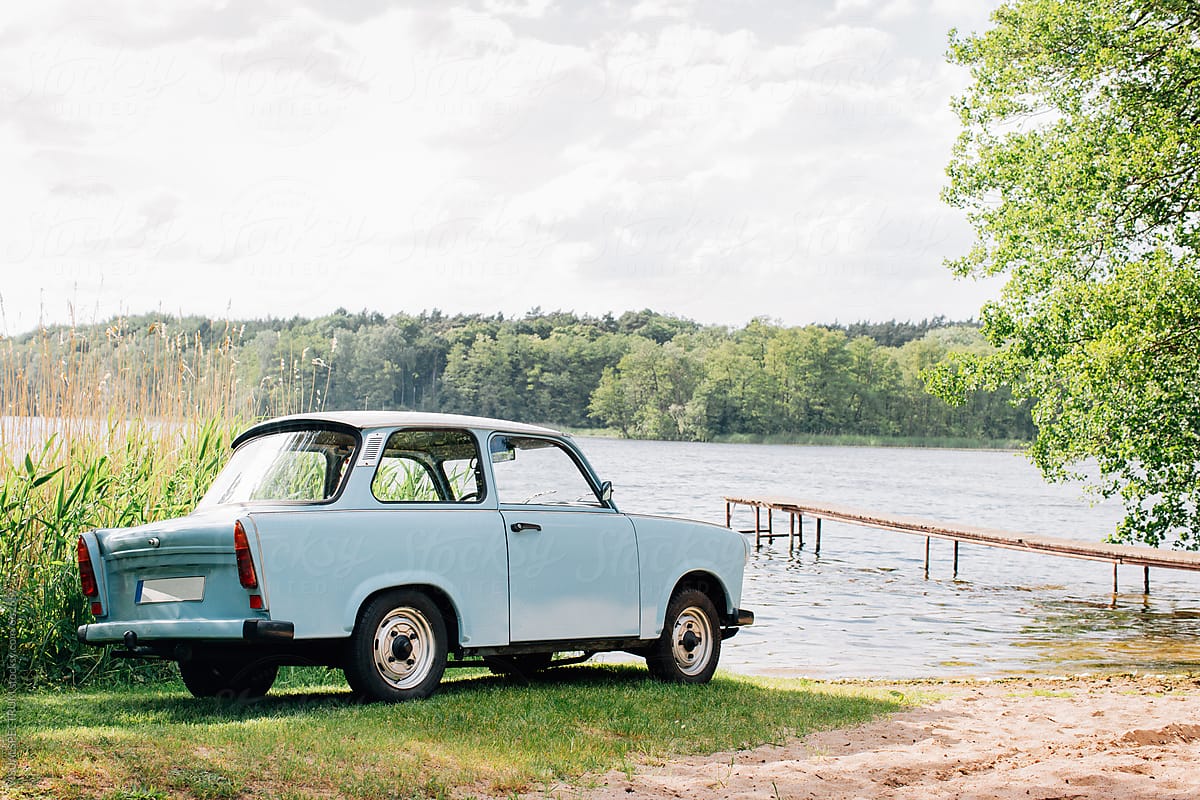 Blue GDR Vintage Car Parked Near Lake on Sunny Summer Day