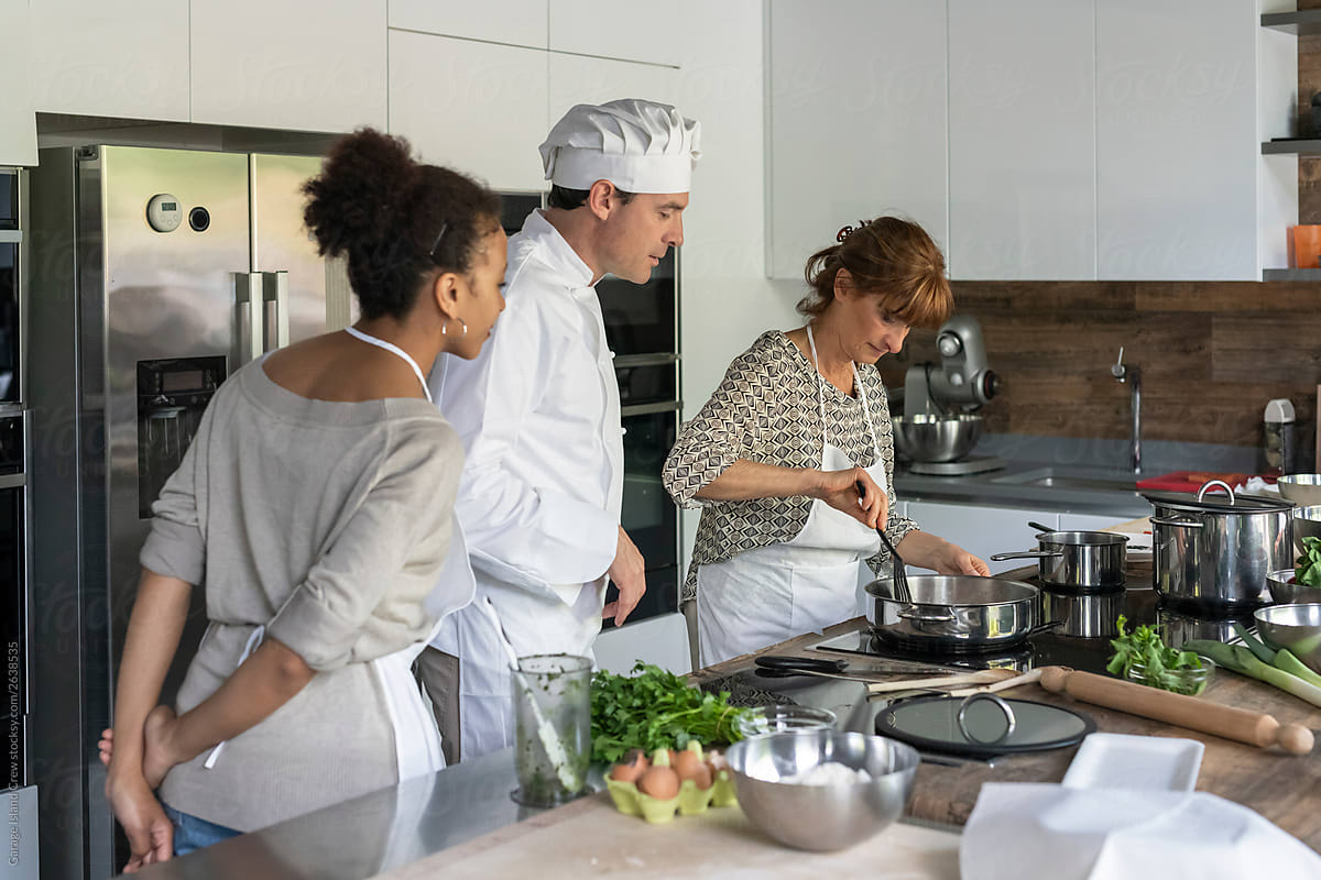 Chef and women cooking together in a kitchen class