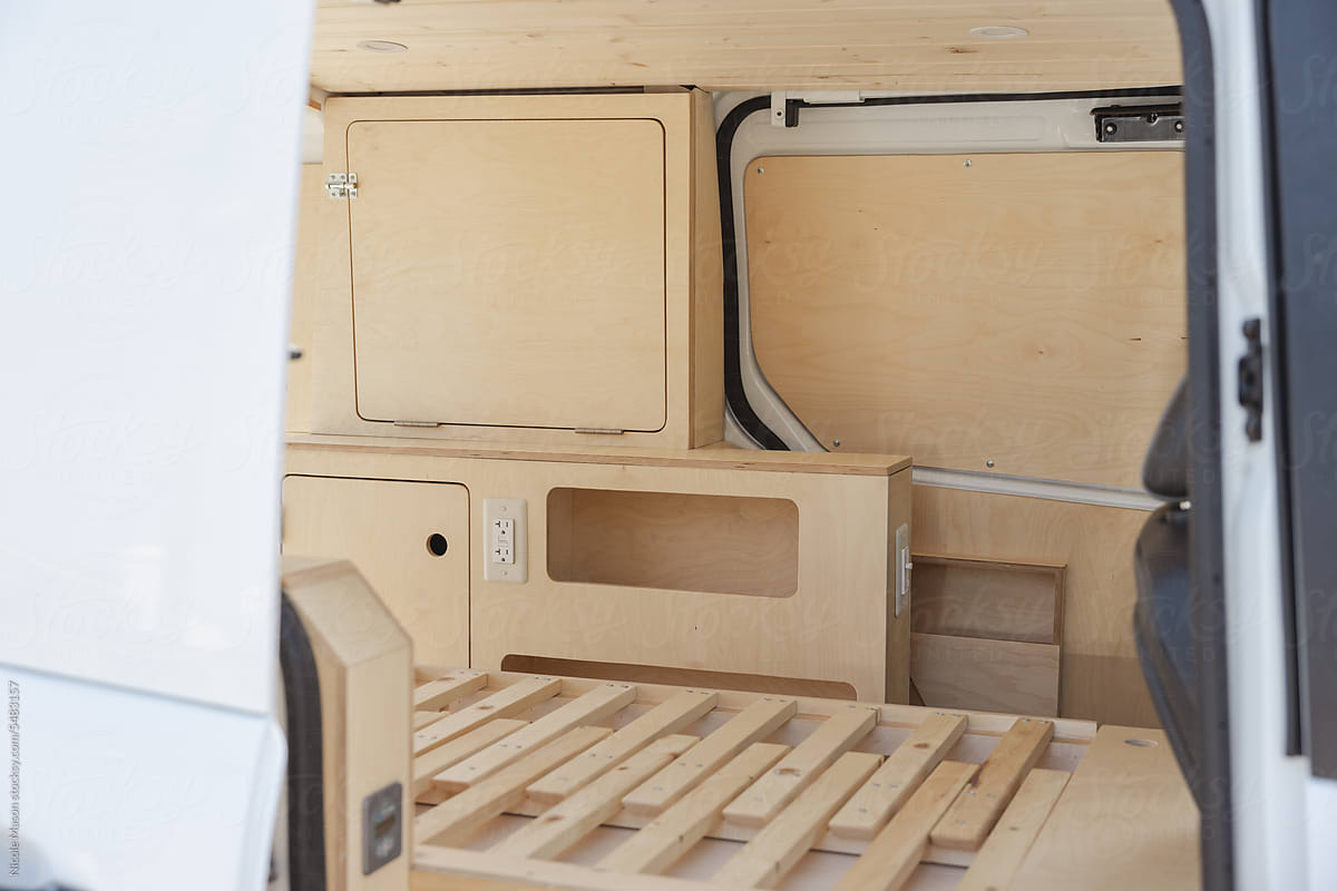 after of a minimalist van build out with light birch wood
