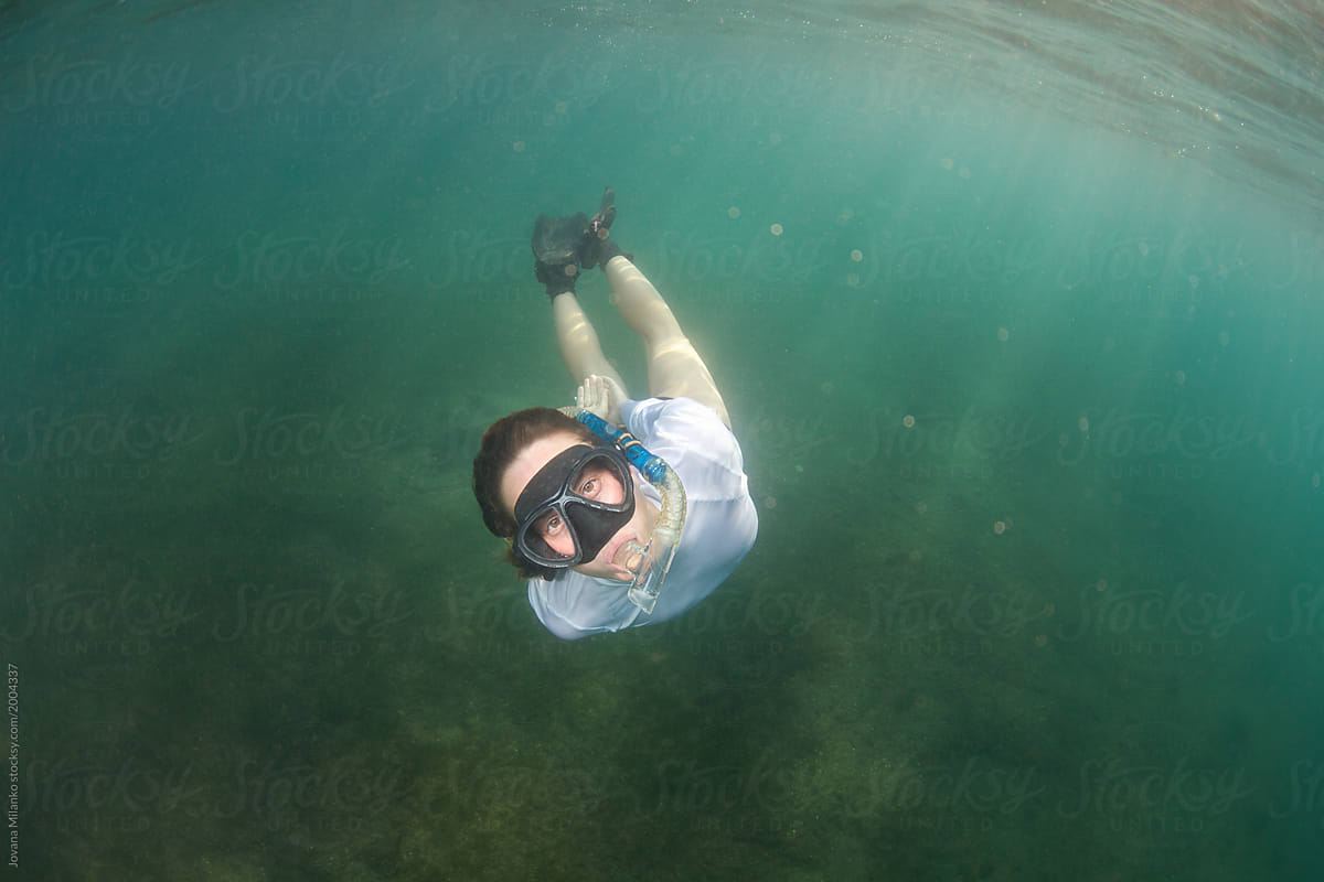 Woman snorkeling submerged underwater