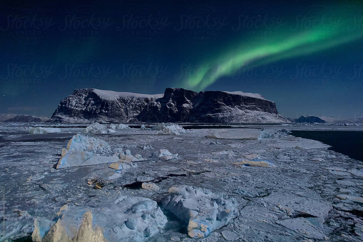 Greenland Arctic winter - aurora northern lights,  sea ice, night sky