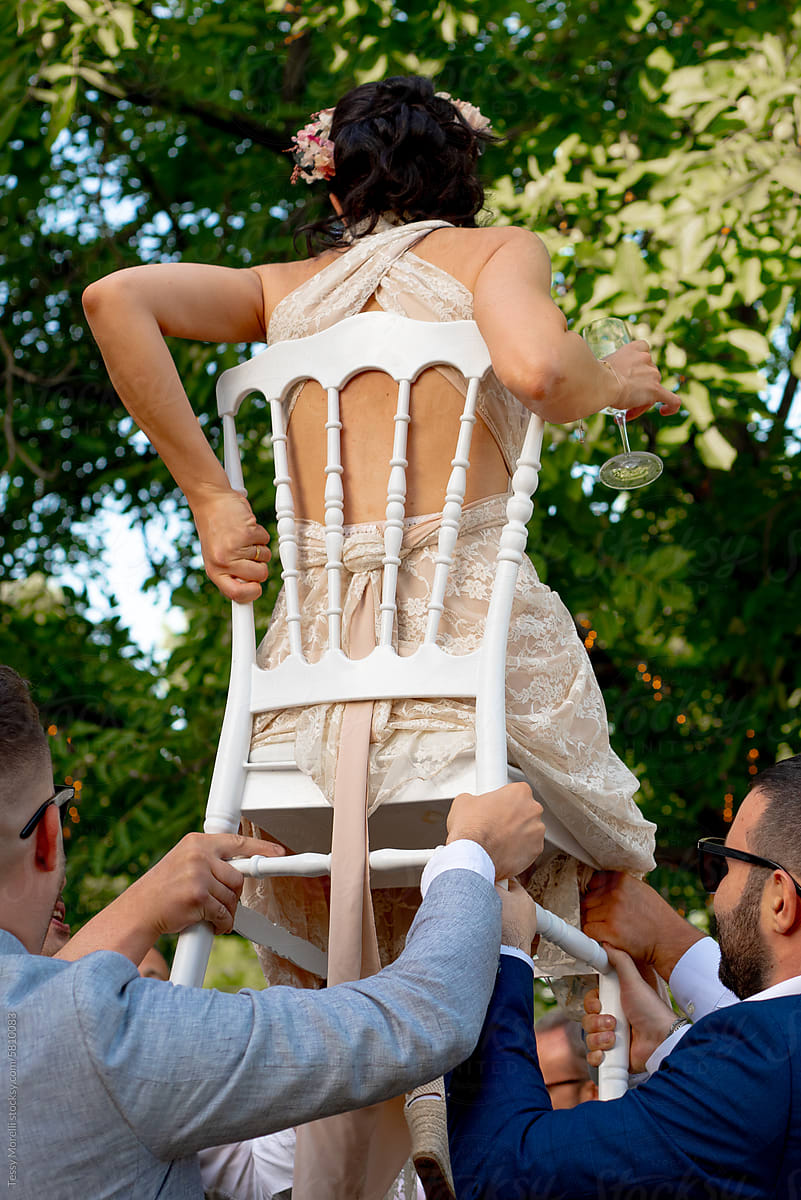 Bride on chair for traditional wedding dance