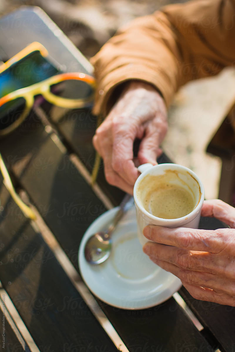 Senior lady having coffee close up hands