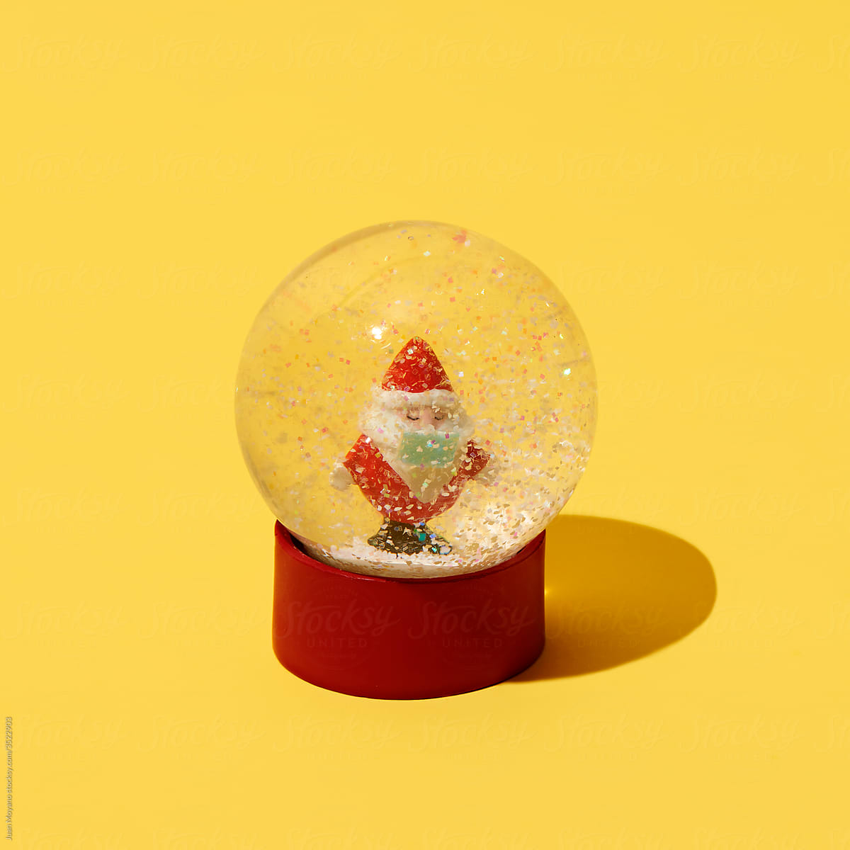 santa claus in a snow globe wearing mask