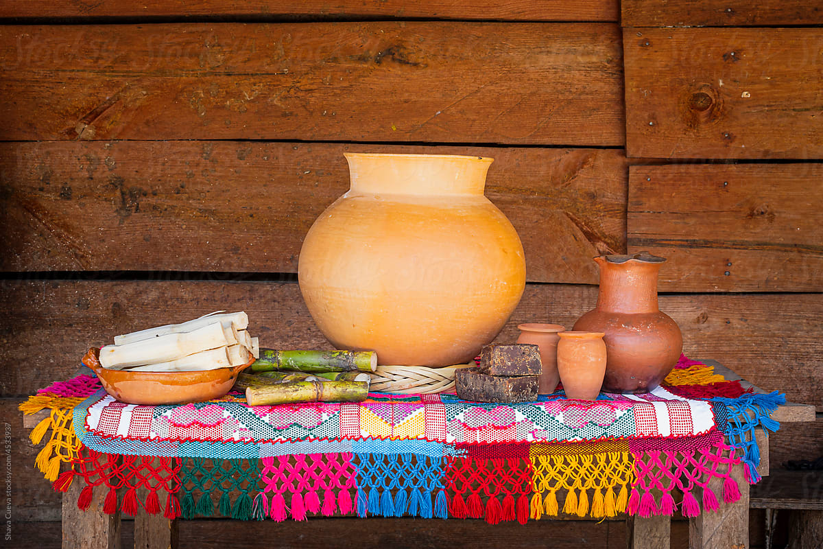 Large clay pot with containers on a colorful tablecloth