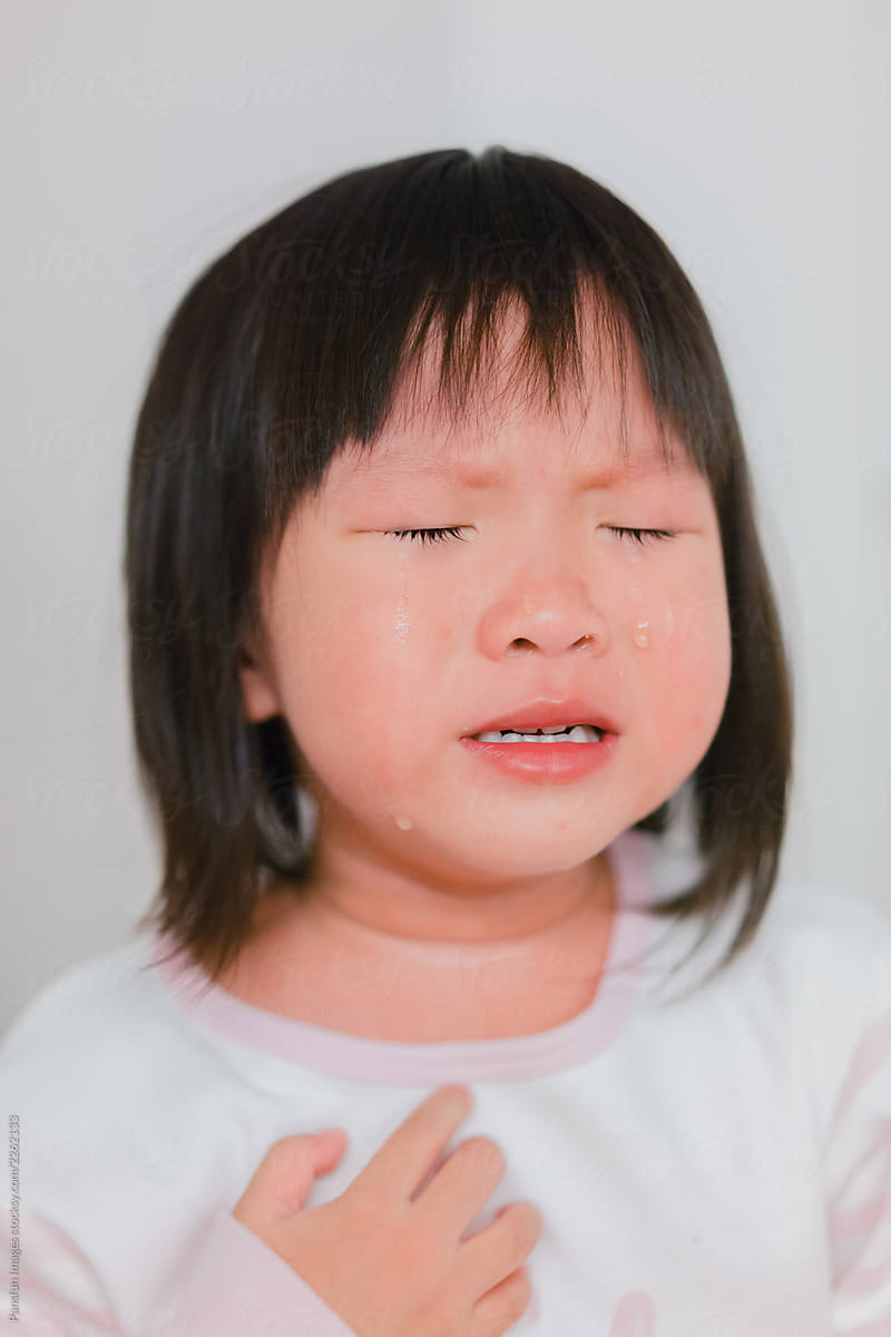 portrait of crying kid with tear