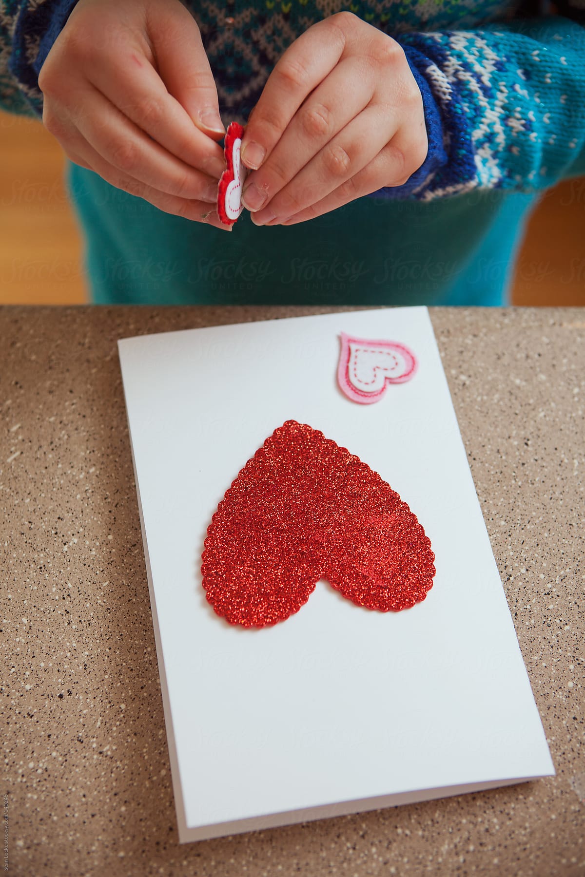 Valentine: Girl Putting Hearts On Card
