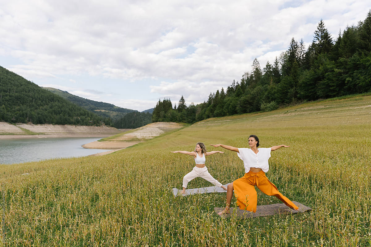 Two Women In A Warrior Yoga Pose