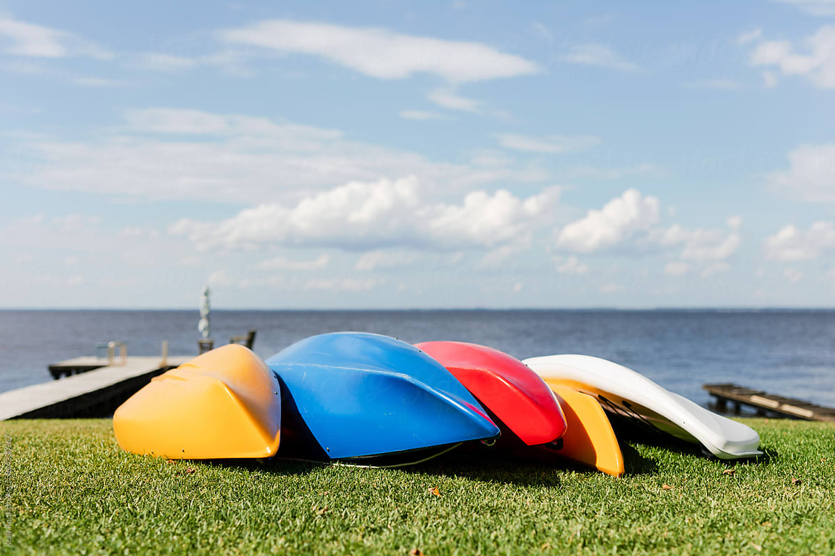 kayaks drying by a lake