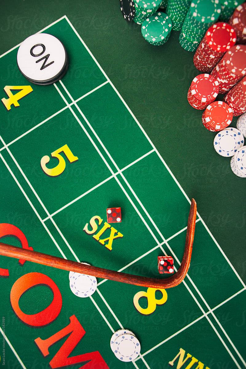Casino: Dealer Uses Stick To Pull In Dice On Craps Table