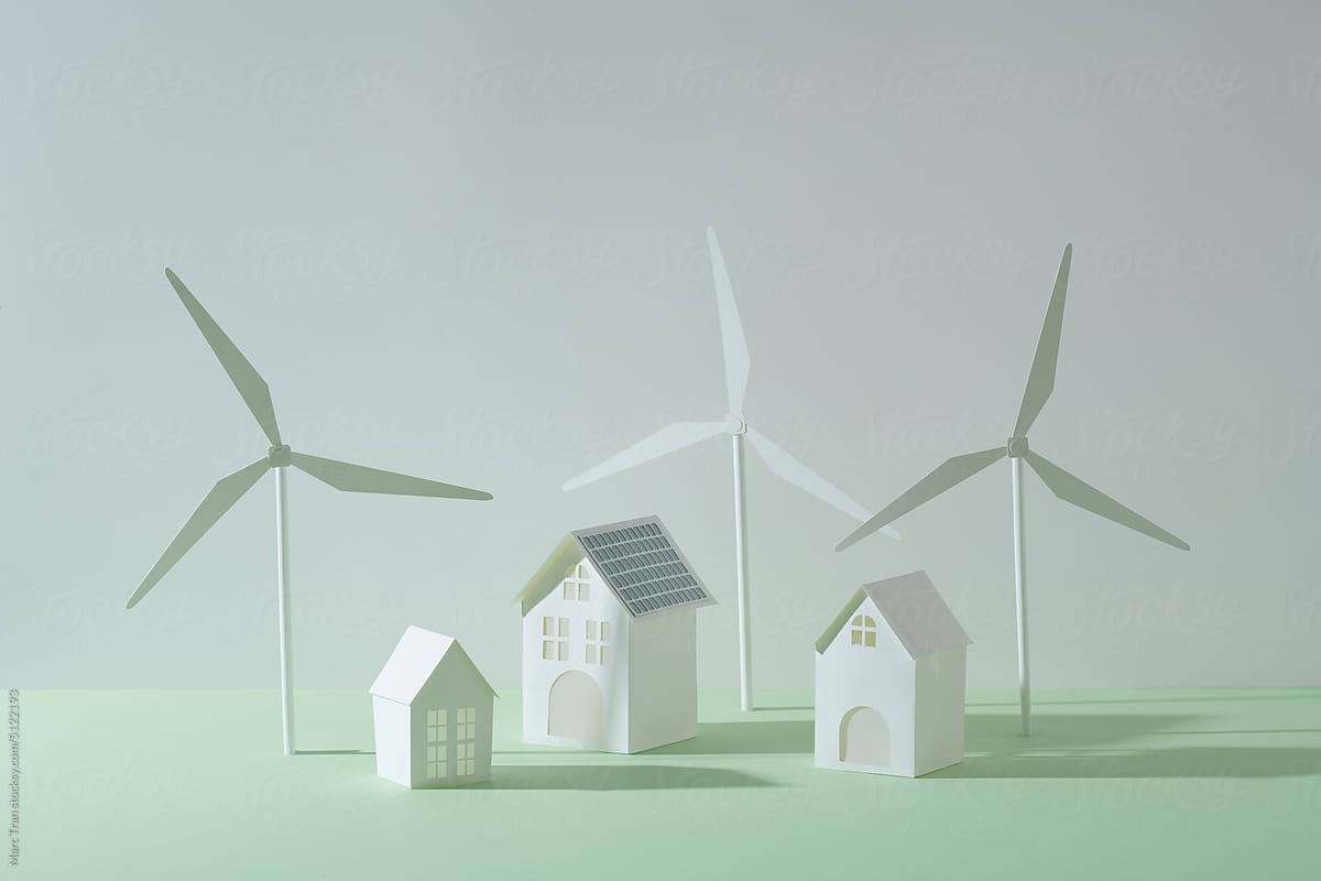 wind turbine and house models on pastel table and white background