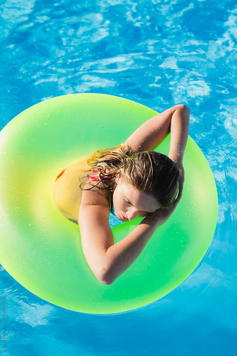 Woman floating on an inflatable ring in a pool
