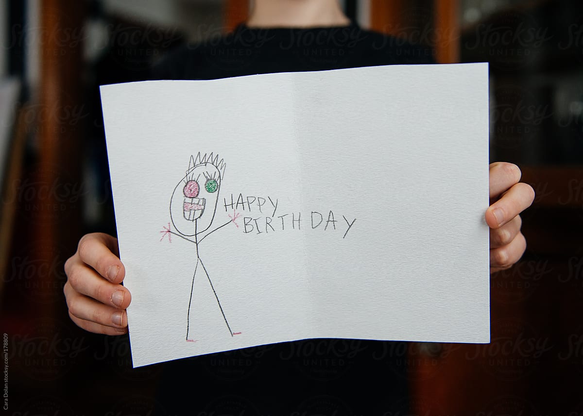 Child shows off a strange little birthday card he\'s made
