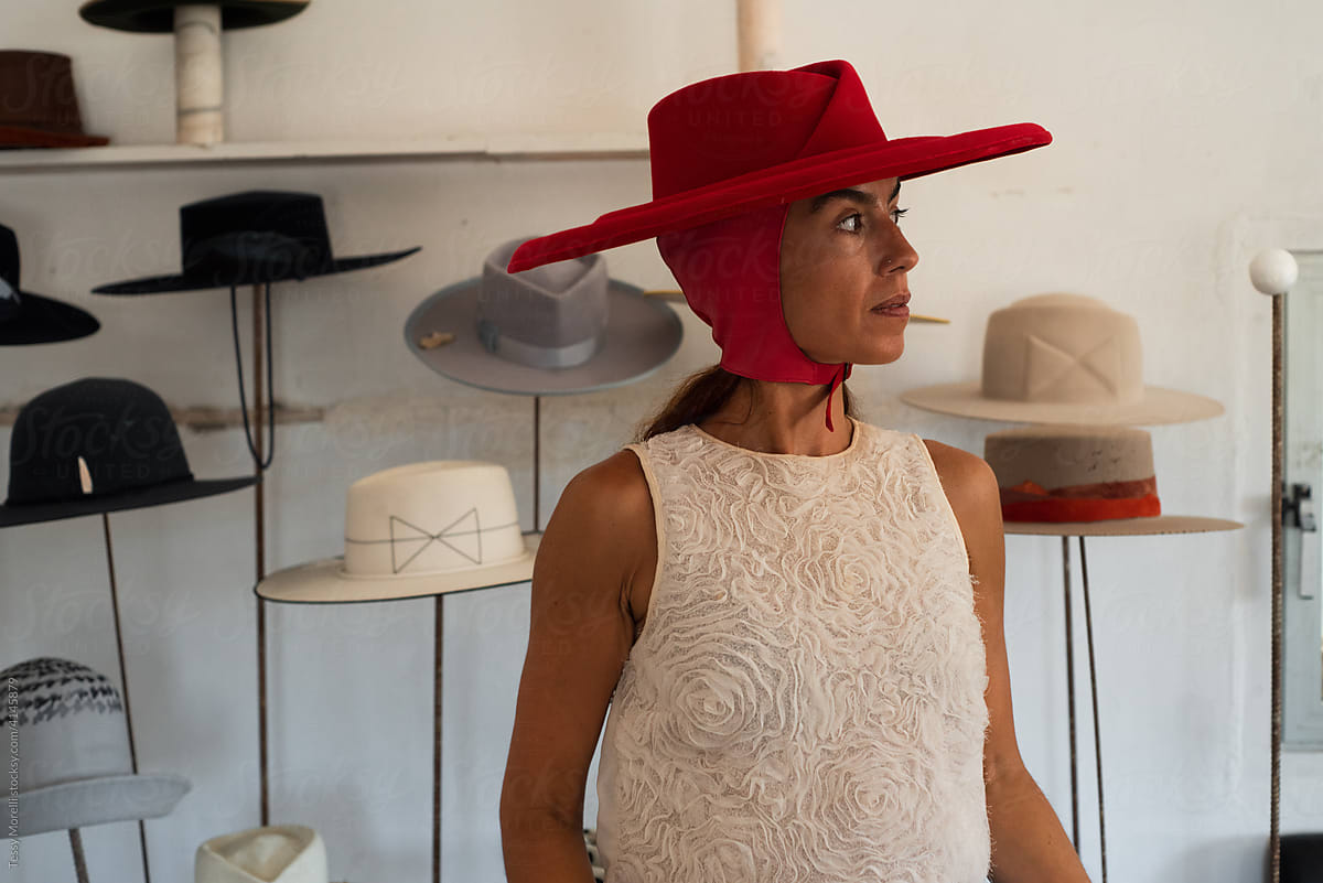 Woman wearing a fedora red hat in the showroom